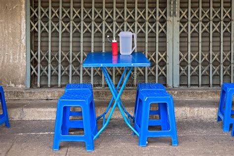 Asian Street Food Dinning Table And Stools On The Pavement Stock Photo