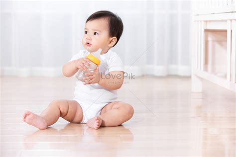 Baby Sitting On The Floor Playing Picture And Hd Photos Free Download