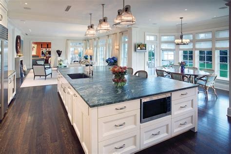 A Large Kitchen With An Island In The Middle And Lots Of Windows On