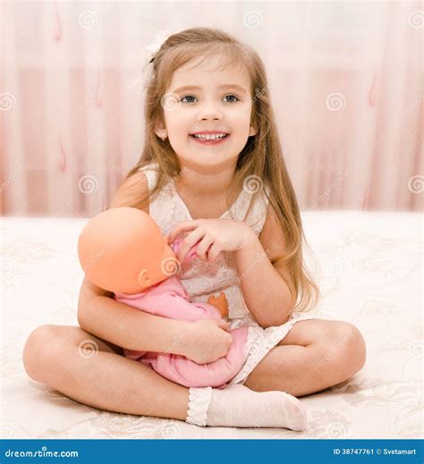 Cute Smiling Little Girl Playing With A Doll Stock Image Image Of