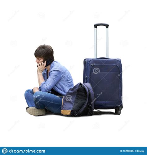 Isolated Photo Of A Sad Woman With A Luggage Sits On The Ground And