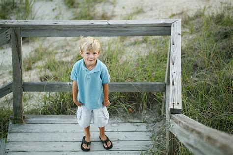 Smiling Boy At The Bottom Of A Beach Boardwalk Del Colaborador De