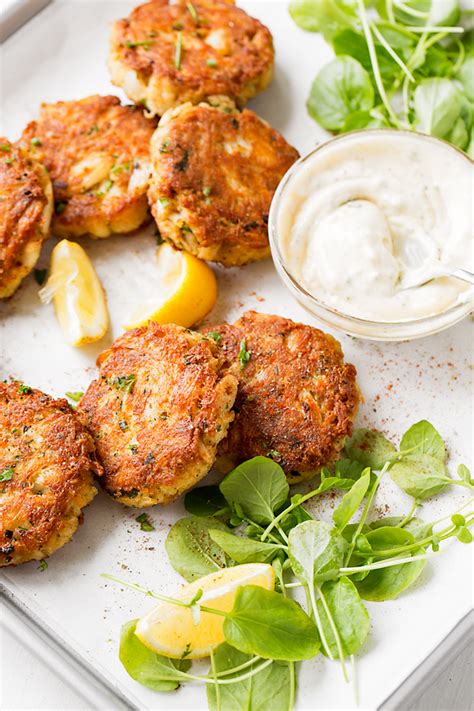 Crab cakes are a special party appetizer, topped with a dollop of mustard sauce, or lemon or lime aioli. Crab Cakes | The Cozy Apron