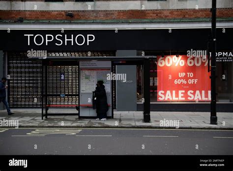 A woman wearing a face mask to curb the spread of coronavirus waits in