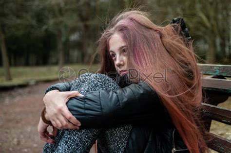 Sad Depressed Young Girl Sitting On A Bench In A Stock Photo 1903465
