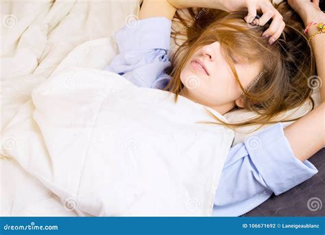 Young Girl Lying In Her Bed With Messy Hair Covering Her Face Stock