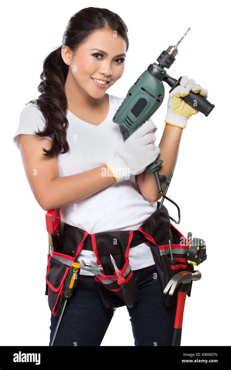 female construction worker wearing a tool belt full of a variety of useful tools hold a