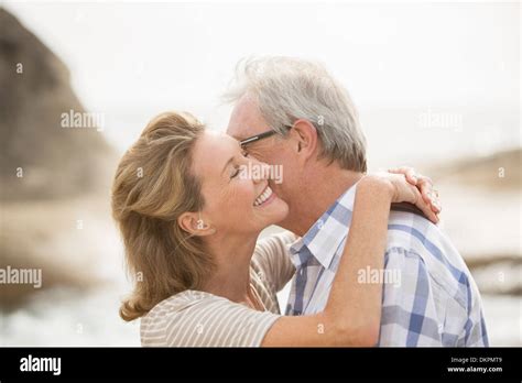 Older Couple Kissing On Beach Stock Photo Alamy