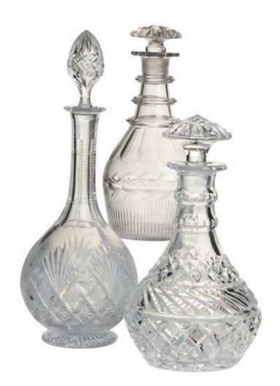 A Pair Of Glass Decanters And Stoppers And A Cut Glass Decanter And Stopper The First