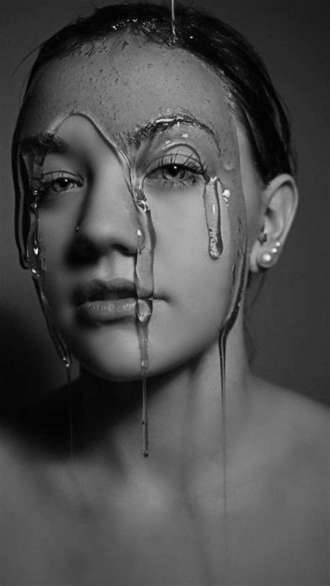 a woman s face covered in dripping water