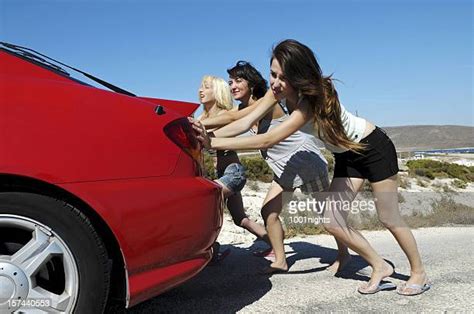 Group Of People Pushing Cars Photos And Premium High Res Pictures