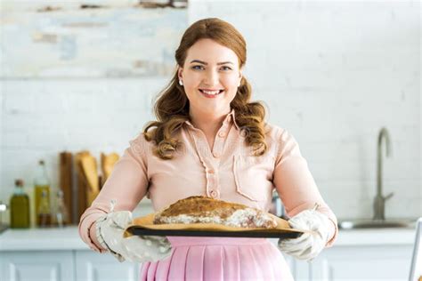 Smiling Beautiful Woman Holding Tray With Fresh Homemade Loaf Of Bread