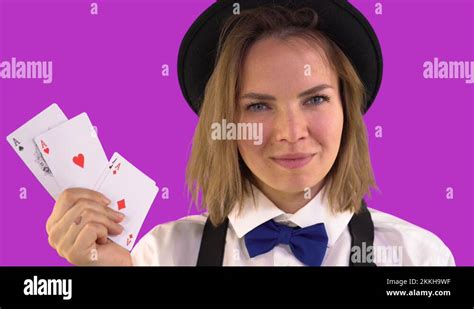 Croupier Girl In A White Shirt And Hat And Bow Tie Shows Playing Cards