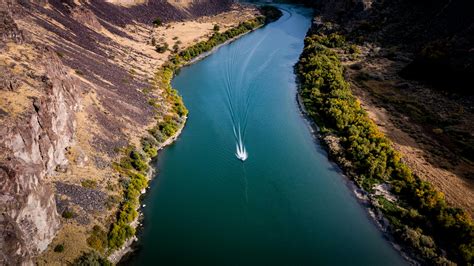 Aerial View Of Boat On River Between Bushes · Free Stock Photo