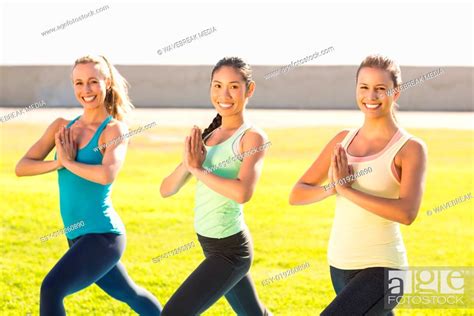 Smiling Sporty Women Doing Yoga Together Stock Photo Picture And Low