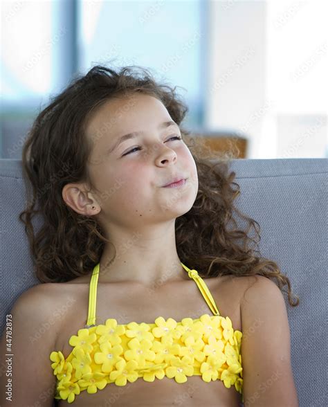 Portrait Of A Beautiful Young Girl In A Yellow Bikini Stock Photo
