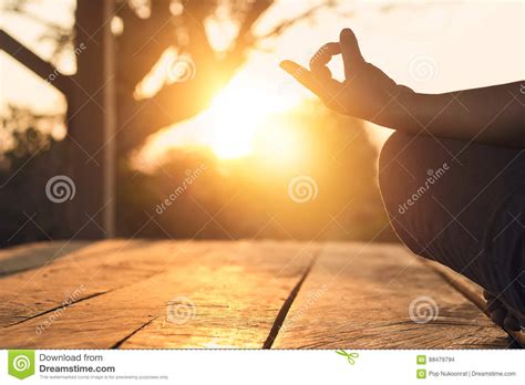 Hand Of Woman Practicing Meditation Yoga On Nature Sunset Stock Photo