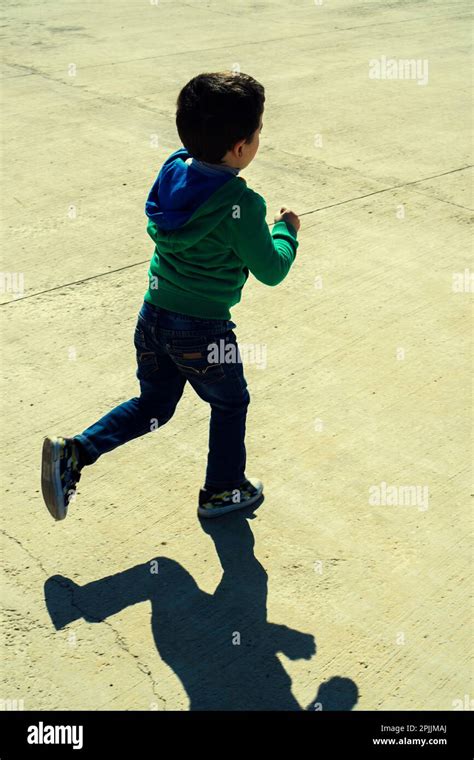 Little Boy Running Away Outdoors Stock Photo Alamy