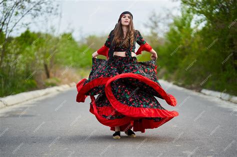 Premium Photo Young Beautiful Gypsy Woman Dancing In The Middle Of The Street In Traditional