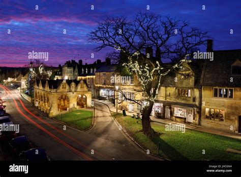 Market Hall And Cotswold Stone Cottages Along High Street At Dusk