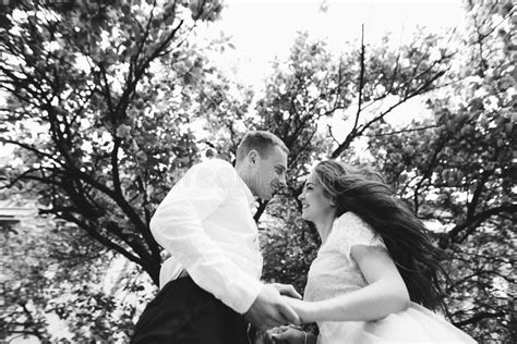 Happy Young Couple In Love Enjoys Spring Day Loving Man Holding On