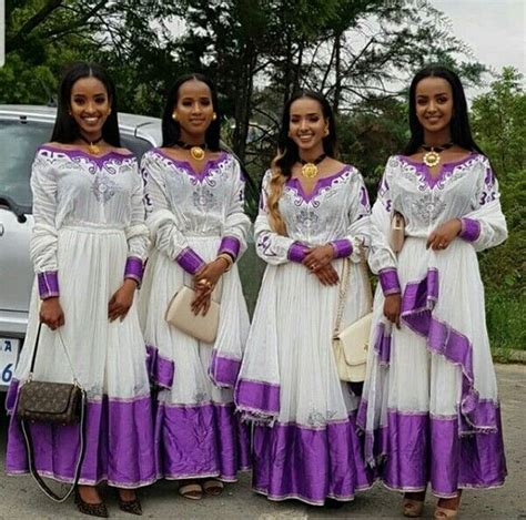 clipkulture ladies in beautiful purple and white habesha kemis traditional attire and gold