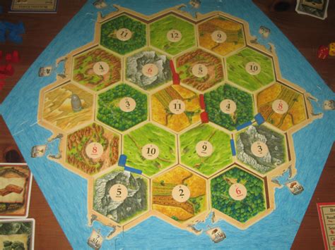 Four building costs cards, one for each player. The Settlers Of Catan | Dad's Gaming Addiction