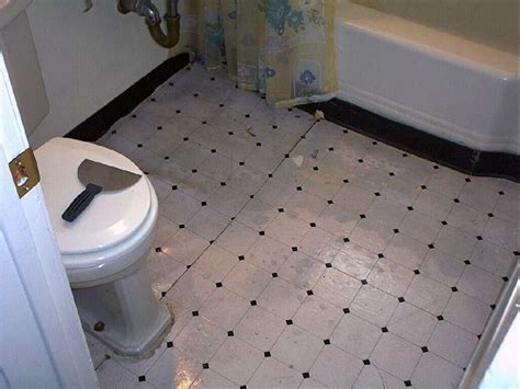 Apply vinyl flooring adhesive at the area of the toilet base with an adhesive trowel. Good lord! What the hell is this? Under the linoleum we ...