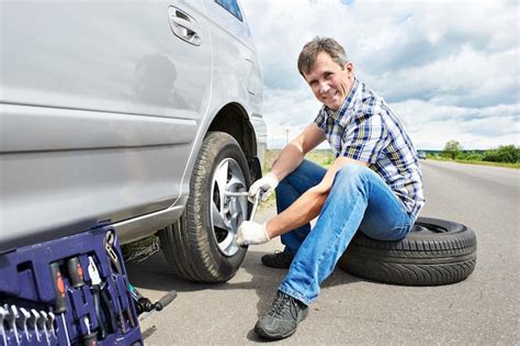Premium Photo Man Changing Spare Tire Of Car