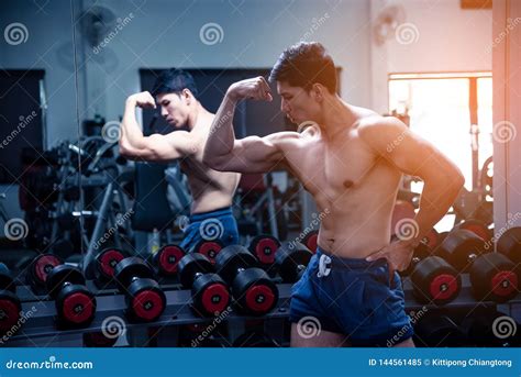 Asian Handsome Young Muscular Asian Man Exercising Bodybuilder In Front