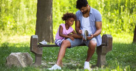 Father Tying Daughters Shoelaces