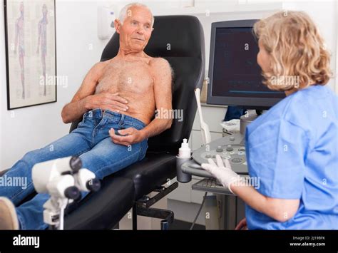 Skillful Doctor Consulting Patient Before Ultrasonography Examination