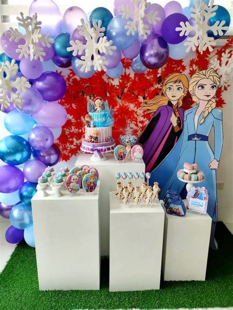 There Is A Cake And Balloons On Display At This Frozen Princess Themed