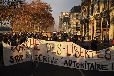 tens of thousands rally in france against security law as police and protesters clash again