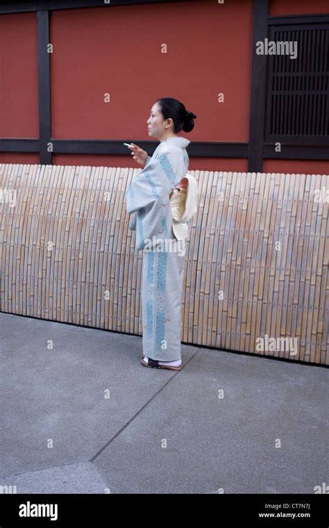 Geisha Girl Smoking A Cigarette In The Japanese City Of Kyoto Japan