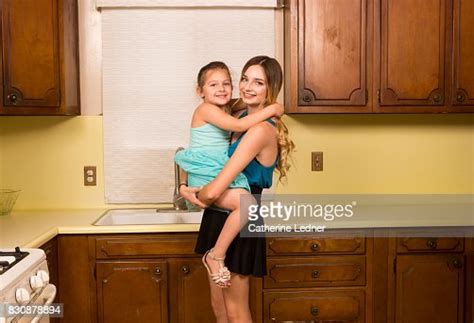 Teenage Girl Holding Her Young Cousin Photo Getty Images