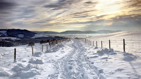 Snow Covered Road Under Beautiful Clouds Wallpapers And
