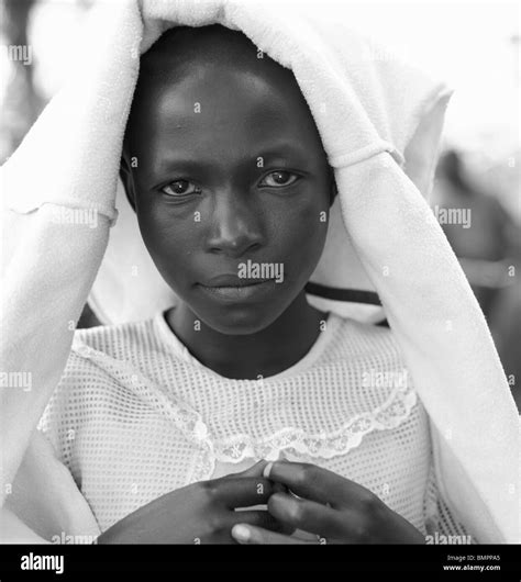 Small Black Girl With A White Jumper On Her Head In Rwanda Post