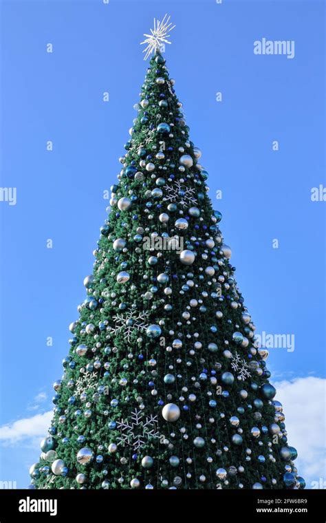 A Large Outdoor Christmas Tree And Decorations For The Holiday Season