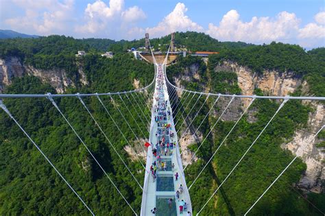 The zhangjiajie bridge in hunan province is 1,410 feet long and is often overwhelmingly crowded with tourists, as. World's longest glass-bottom bridge opens in China