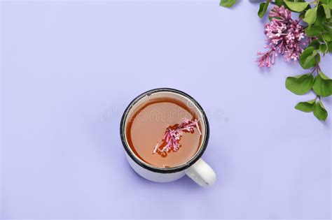 Lilac Flowers With Cup Of Tea On Colourful Background Stock Photo