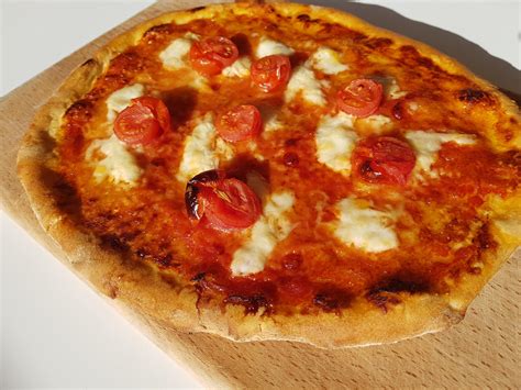 Homemade Neapolitan Pizza With Buffalo Mozzarella And Cherry Tomatoes