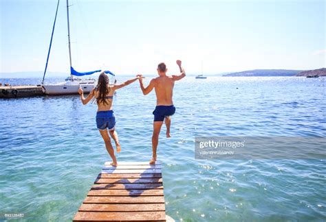 Couple Jumping Into Water High Res Stock Photo Getty Images