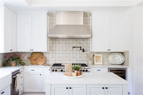 The kitchen backsplash is placed on the kitchen wall between the countertops and the wall cabinets. 27 Kitchen Tile Backsplash Ideas We Love