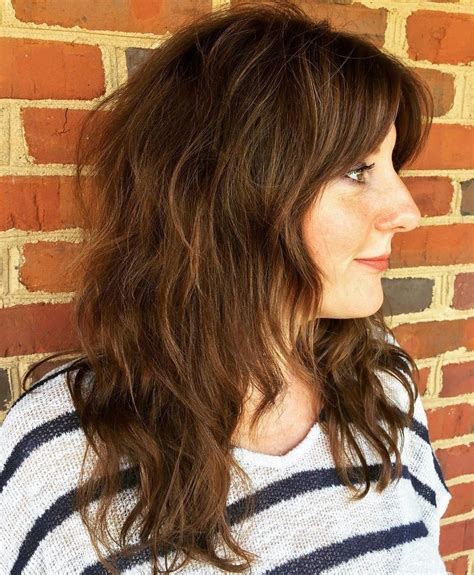 wavy shaggy brown hairstyle with curtain bangs medium shaggy hairstyles shag hairstyles