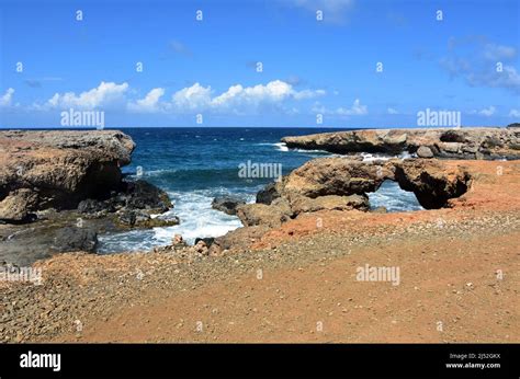 Natural Bridge Formation On The Black Stone Beach In Aruba Stock Photo