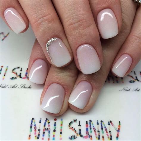 A Woman S Hand With White And Pink Nail Polish