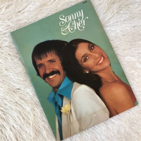 A Magazine With An Image Of A Man And Woman On The Cover Is Laying On A