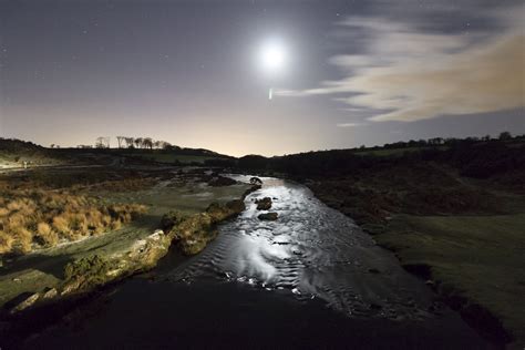 The Moon Brilliantly Shines A Light Over The River Over The River