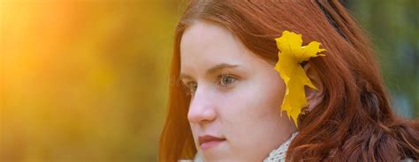 Portrait Of A Red Haired Smiling Girl In A Jacket And Scarf With Her